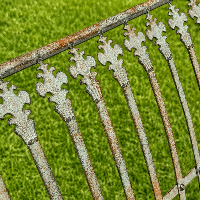 Patinated verdigris metal garden bench, close-up of the patina