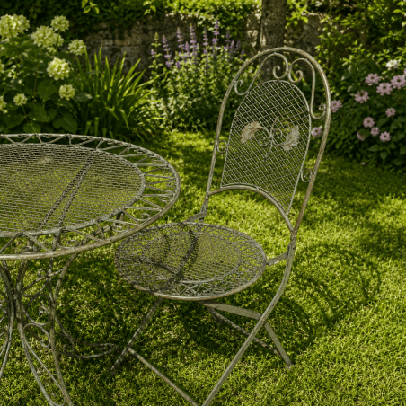 Two-seat wrought-iron garden set with a verdigris patina, chair view