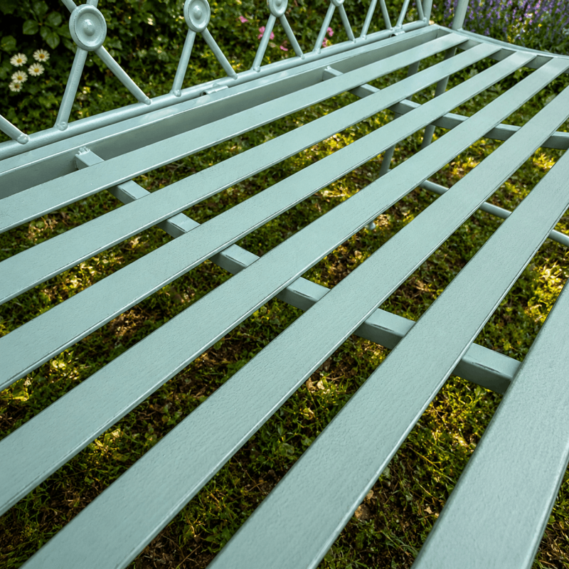 Seafoam green garden bench in weathered metal – close-up of the patina