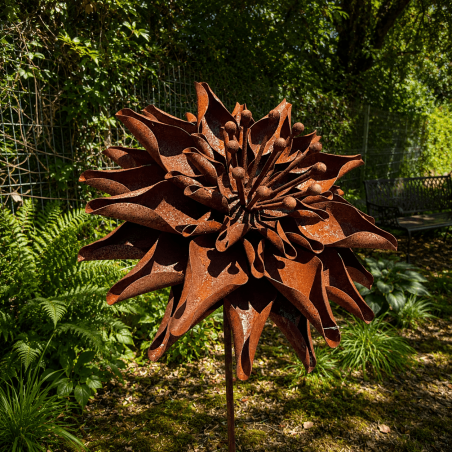 Rust-colored metal dahlia on a stake