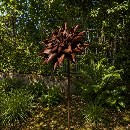 Rust-colored metal dahlia on a stake