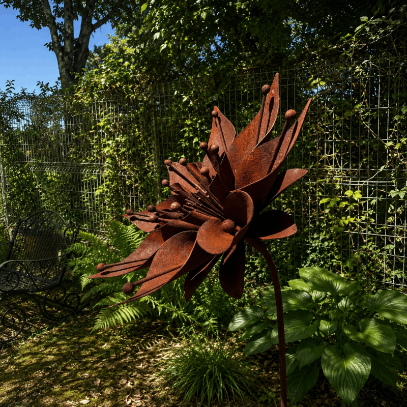 Star-shaped metal flower on a rusty stake – side view