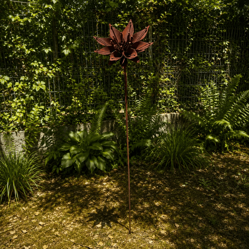 Rusty metal star flower on a stake – overview