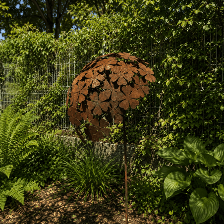 Rust-colored metal allium on a stake — side view