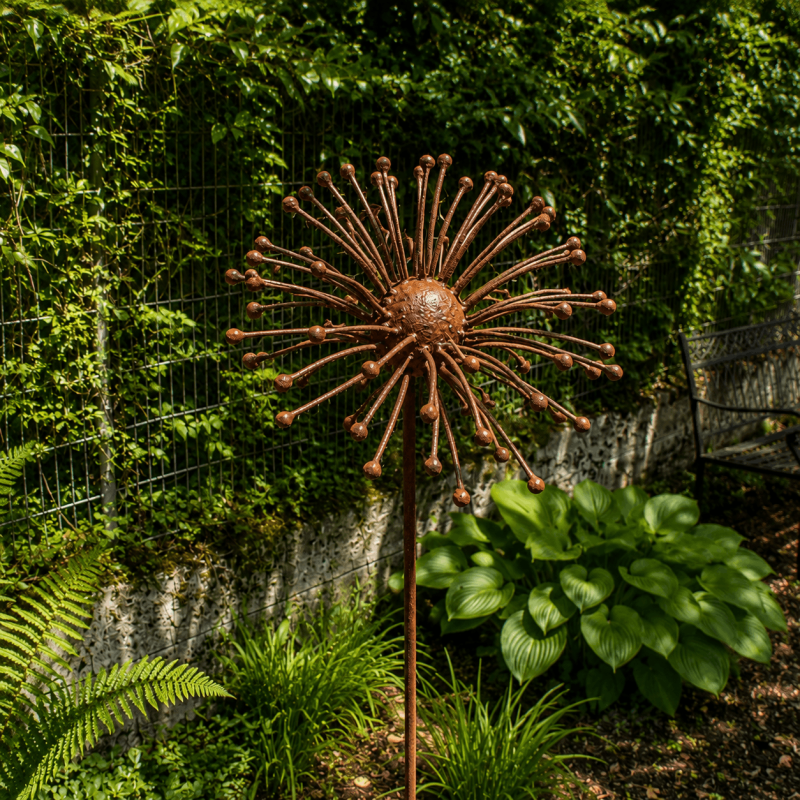 Rust-colored metal sun flower on a stake