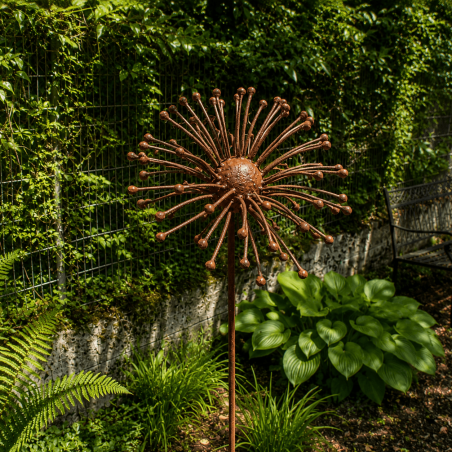Rust-colored metal sun flower on a stake