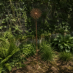 Rust-colored metal sunflower on a stake—overall view