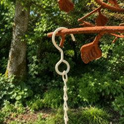 Heart-shaped garden planter suspended from metal chain