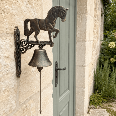 Cast iron doorbell with a brown, slightly gilded horse design
