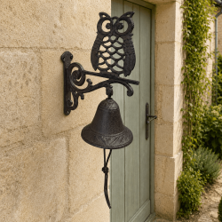 Cast iron doorbell with an openwork owl and bronze-brown patina