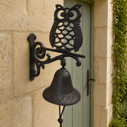 Decorative wall-mounted owl doorbell with an ornate bell